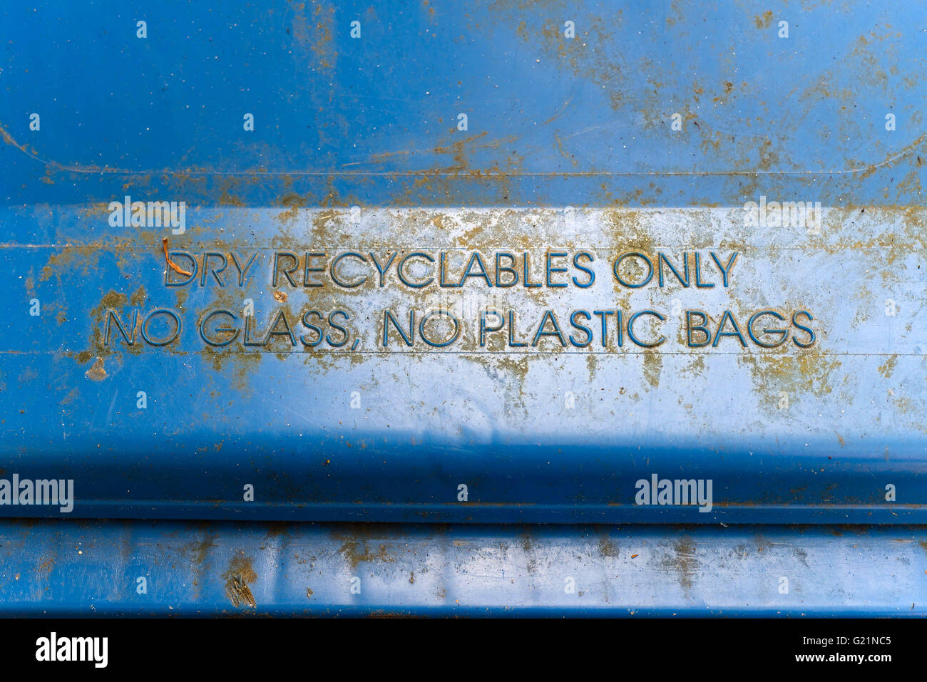dry recyclables only no glass no plastic bags on blue bin` Stock Photo